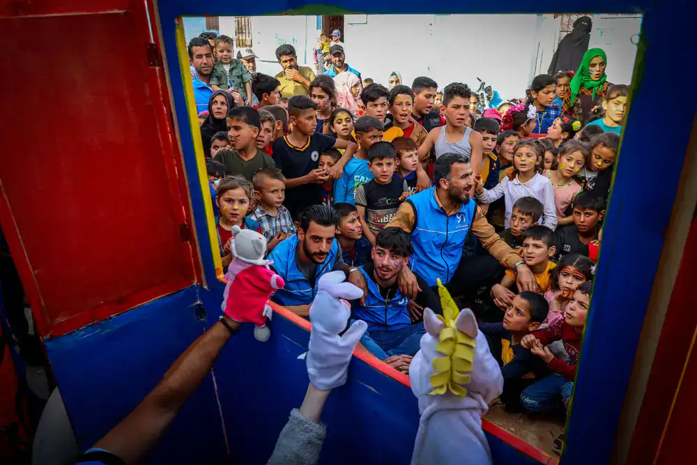 Audience watching an intimate puppet performance