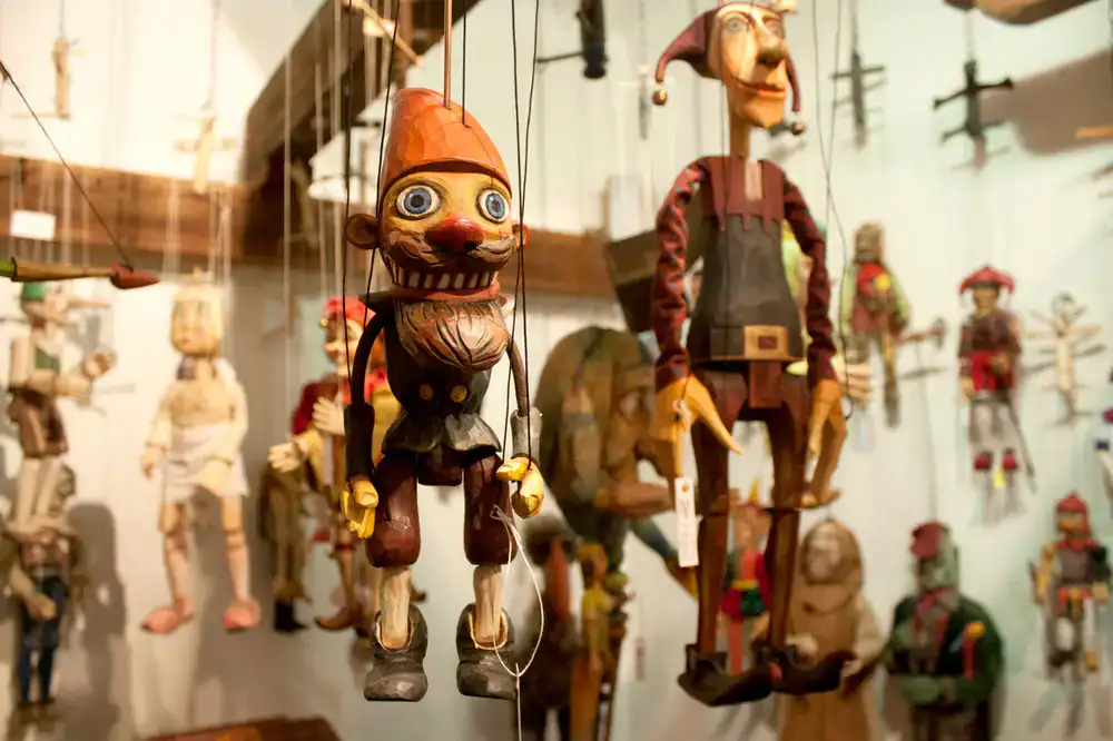 A beautifully crafted marionette under warm stage lighting